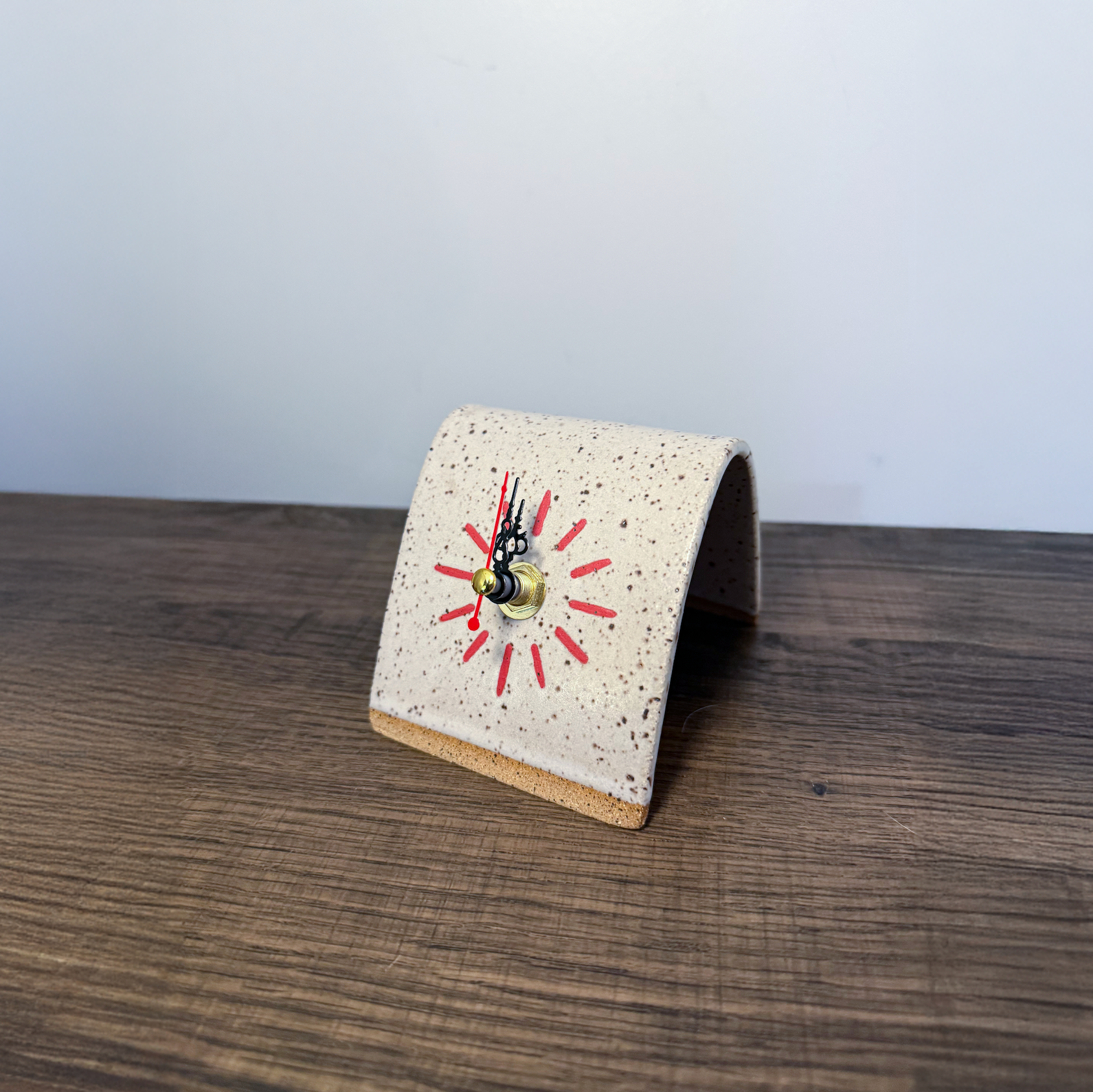 White ceramic desk clock on wooden table